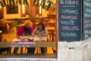 dos mujers leen en un bar fotografia callejera rosario
