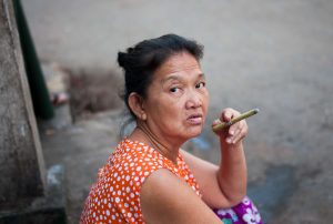 street photography seller woman smoking cigar in yangoon